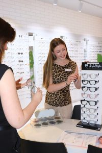 Optometrist helping a customer select a pair of prescription safety eyewear.